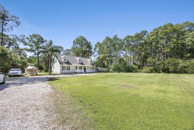 view of front of house featuring driveway and a front lawn