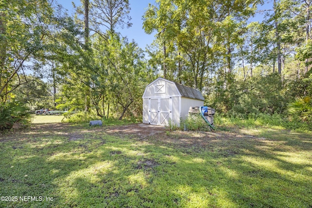 view of green lawn with a shed and an outdoor structure