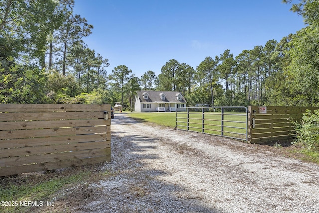 view of dirt / gravel road with a gate and a gated entry
