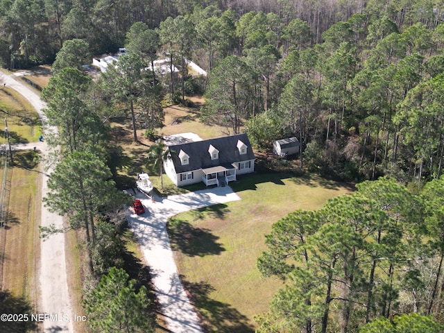 aerial view of property's location featuring a heavily wooded area