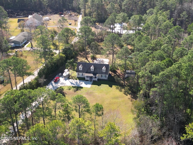 view of property location featuring a forest