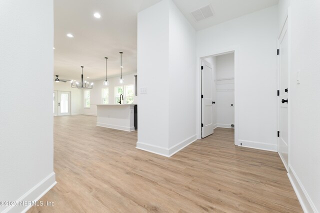 959 Florida St, Fleming Island, FL 32003 - hallway with a chandelier, light wood-style flooring, recessed lighting, a sink, and baseboards