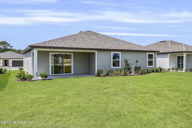 37322 Whisper Way, Hilliard, FL 32046 - back of house with cooling unit, roof with shingles, a yard, and a patio