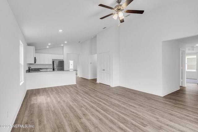 37322 Whisper Way, Hilliard, FL 32046 - unfurnished living room with ceiling fan, light wood-style flooring, recessed lighting, baseboards, and high vaulted ceiling