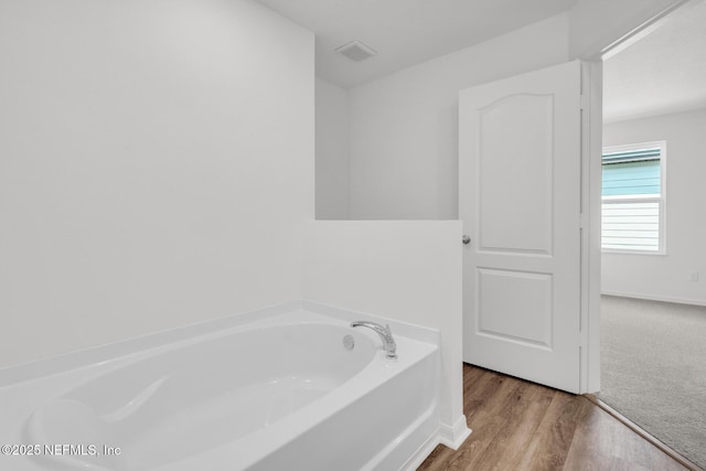 37127 Whippoorwill Ct, Hilliard, FL 32046 - bathroom featuring a bath and wood finished floors