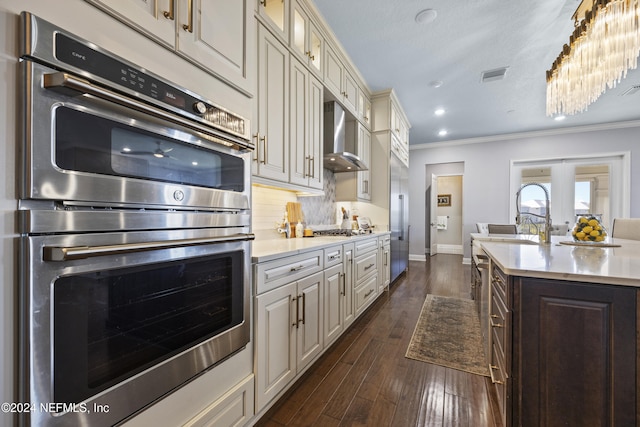 228 Rum Runner Way, Saint Johns, FL 32259 - kitchen featuring wall chimney exhaust hood, stainless steel appliances, light countertops, crown molding, and a sink