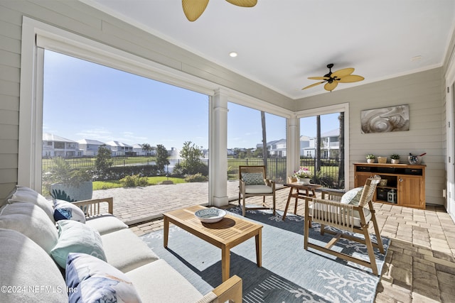 228 Rum Runner Way, Saint Johns, FL 32259 - living area with ceiling fan, crown molding, a residential view, and wood walls