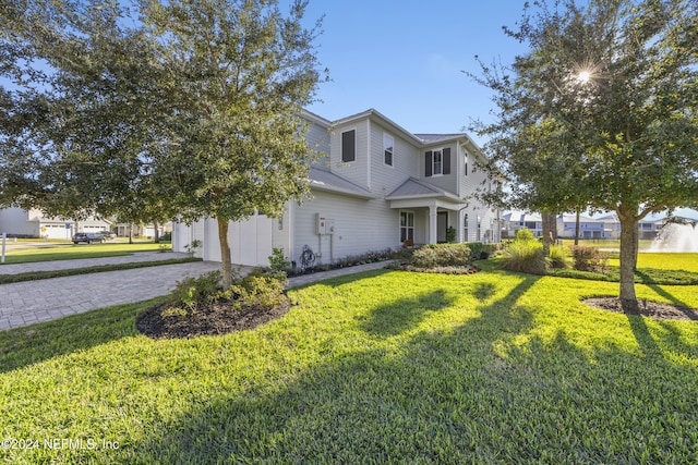 228 Rum Runner Way, Saint Johns, FL 32259 - view of front of house featuring a front yard, driveway, metal roof, a standing seam roof, and an attached garage