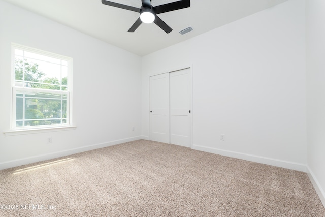 965 Florida St, Fleming Island, FL 32003 - unfurnished bedroom featuring baseboards, carpet, a closet, and a ceiling fan