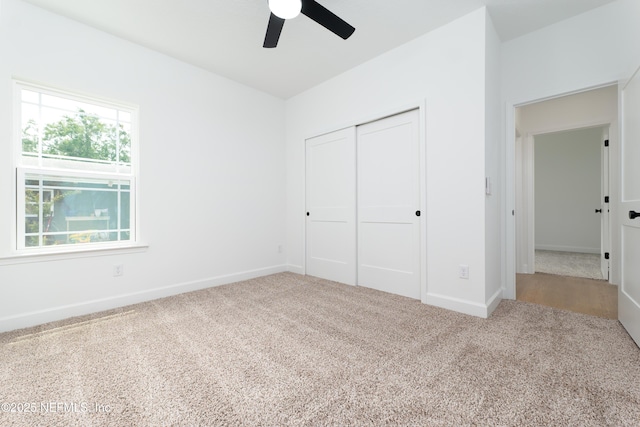 965 Florida St, Fleming Island, FL 32003 - unfurnished bedroom featuring carpet floors, a closet, baseboards, and a ceiling fan