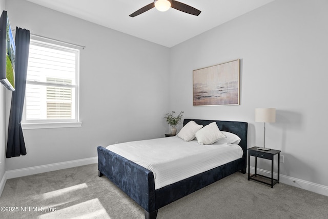 carpeted bedroom with baseboards and a ceiling fan