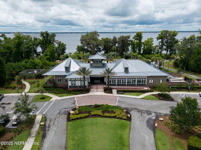 aerial view of property and surrounding area featuring a nearby body of water