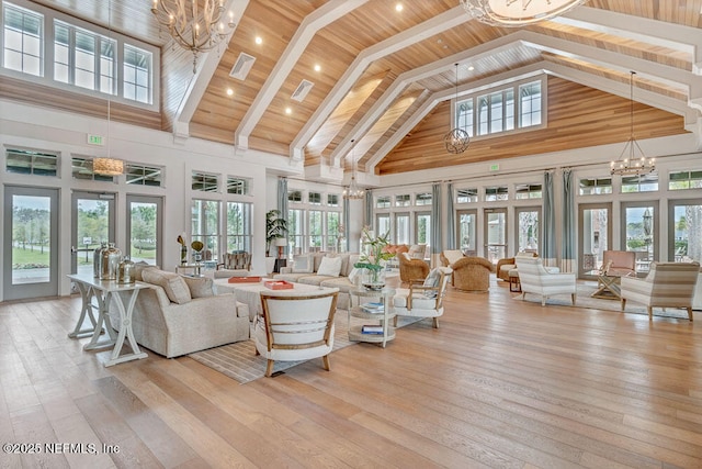 living area with a chandelier, high vaulted ceiling, wooden ceiling, light wood-style flooring, and french doors