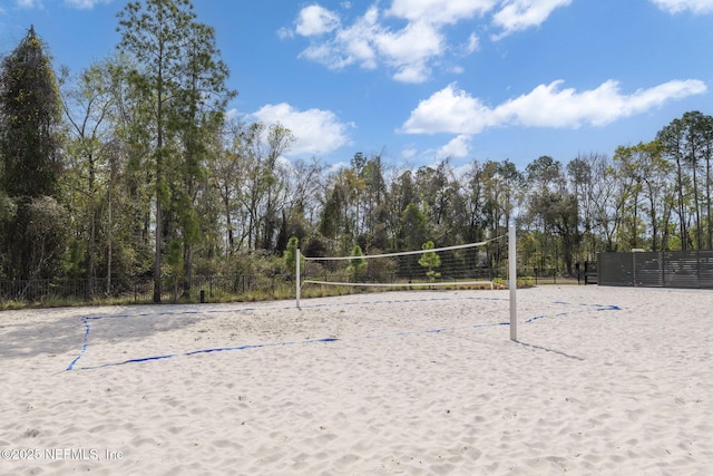 view of home's community featuring fence and volleyball court