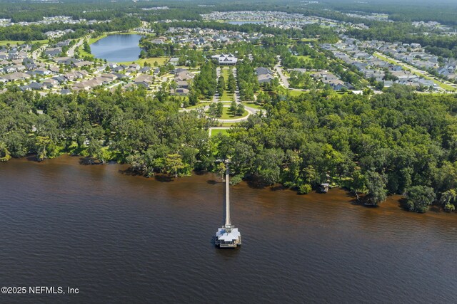 aerial view of property's location with a nearby body of water and nearby suburban area