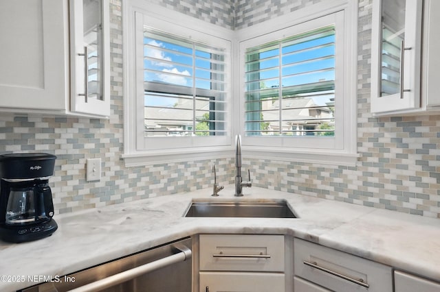 39 Walkers Ridge Dr, Ponte Vedra Beach, FL 32082 - kitchen with a sink, glass insert cabinets, white cabinetry, and decorative backsplash