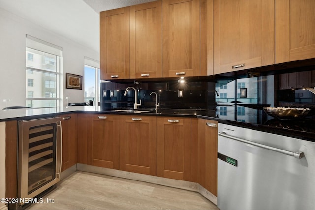 kitchen featuring beverage cooler, stainless steel dishwasher, dark countertops, a peninsula, and tasteful backsplash