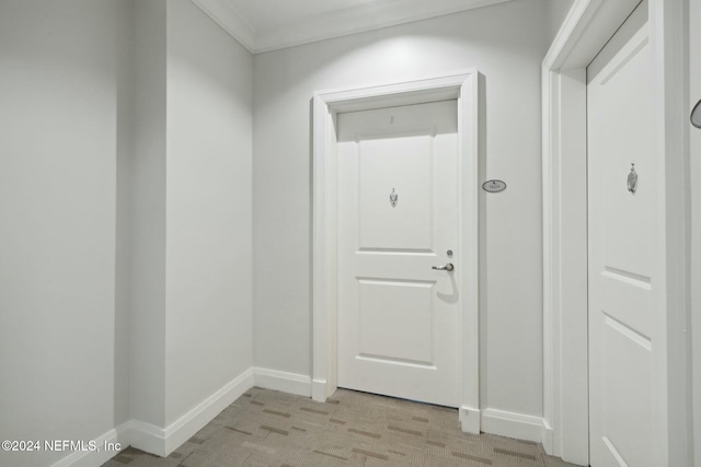 doorway featuring baseboards and crown molding