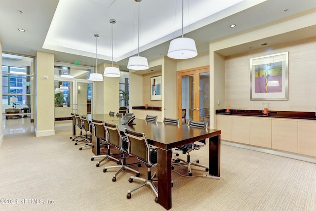 office with french doors, light colored carpet, a raised ceiling, recessed lighting, and baseboards