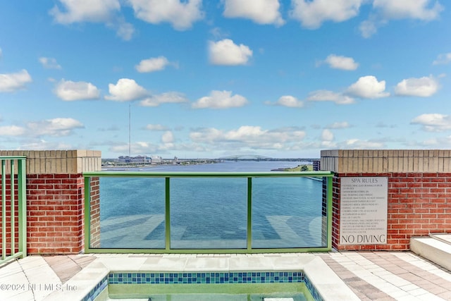 view of pool with a water view