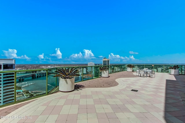 view of patio / terrace with a water view and a balcony