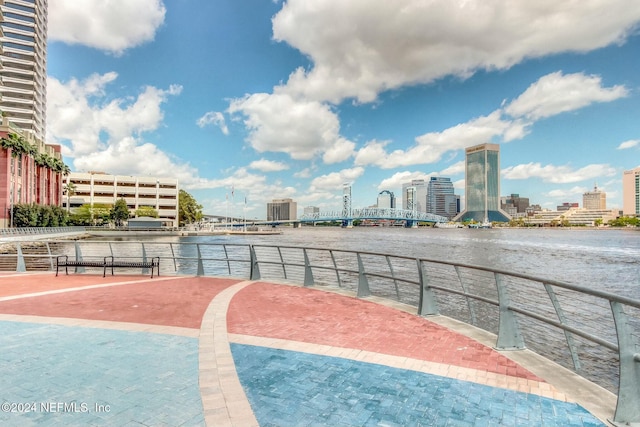 view of swimming pool featuring a city view and a water view