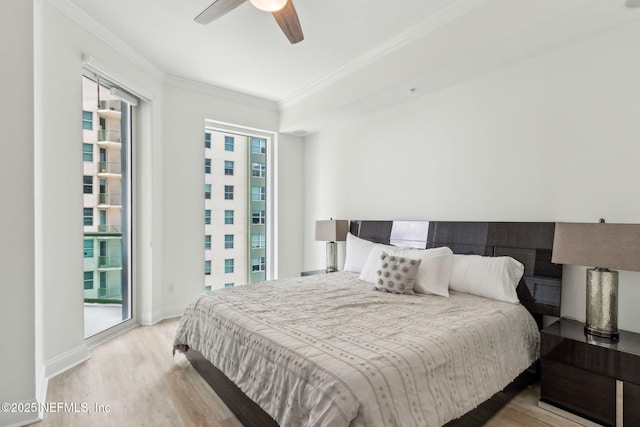bedroom featuring crown molding, wood finished floors, ceiling fan, access to outside, and baseboards