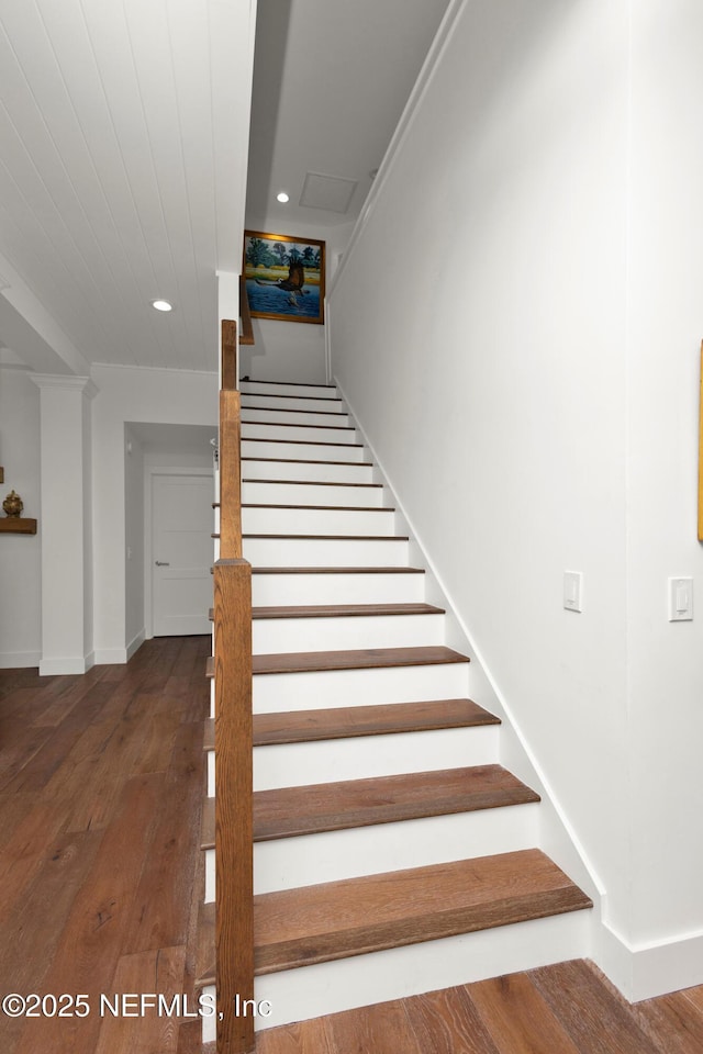 stairway with hardwood / wood-style flooring, baseboards, and recessed lighting