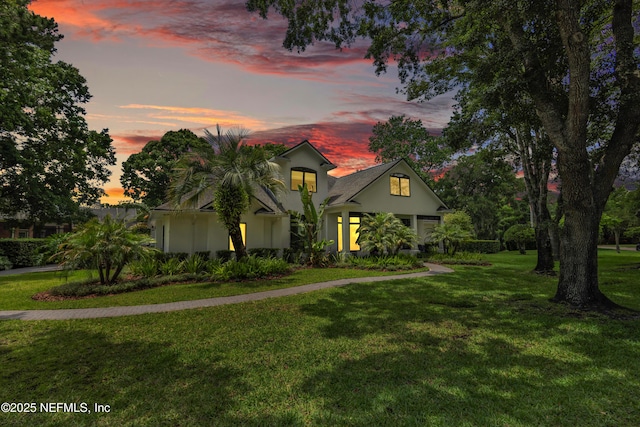 view of front of property with a yard and stucco siding