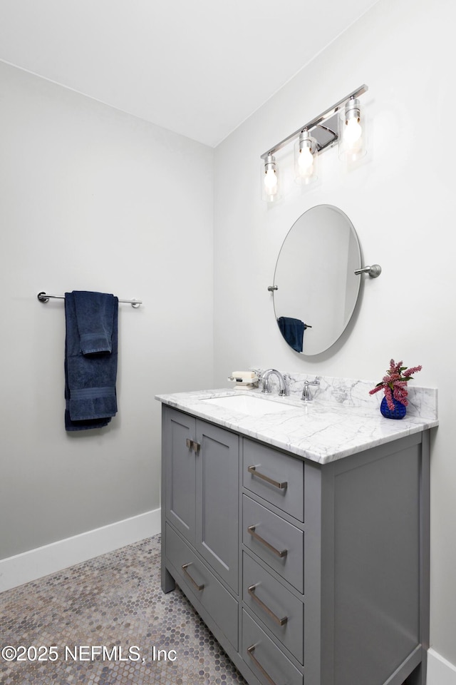 bathroom featuring baseboards and vanity