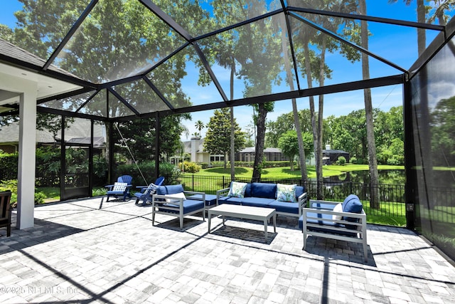 view of patio with an outdoor hangout area and glass enclosure