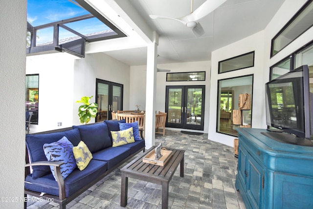 living area featuring french doors and a ceiling fan