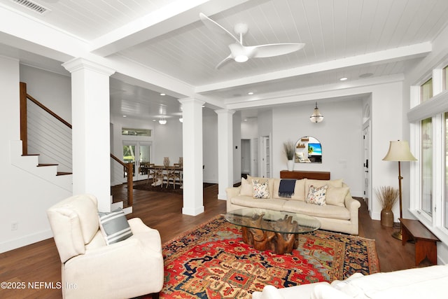 living room with decorative columns, beam ceiling, a ceiling fan, stairway, and wood finished floors