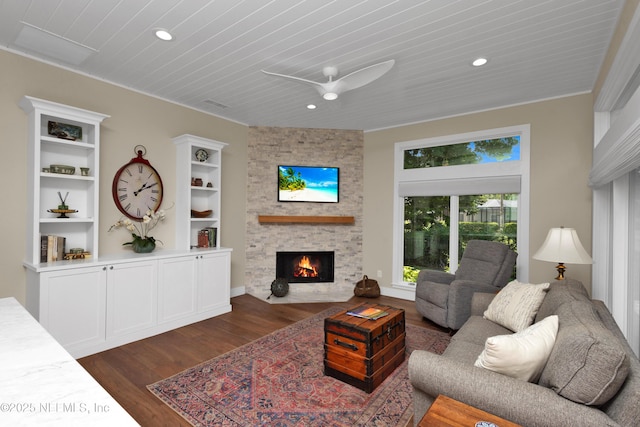living area with a fireplace, dark wood finished floors, ceiling fan, recessed lighting, and wood ceiling