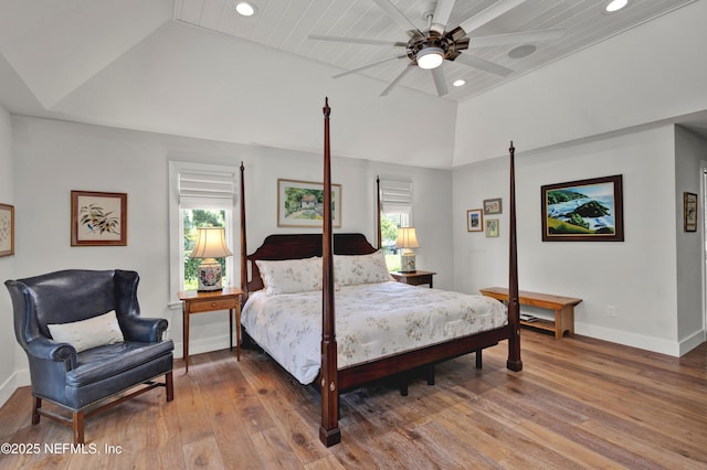 bedroom featuring lofted ceiling, recessed lighting, wood-type flooring, and baseboards
