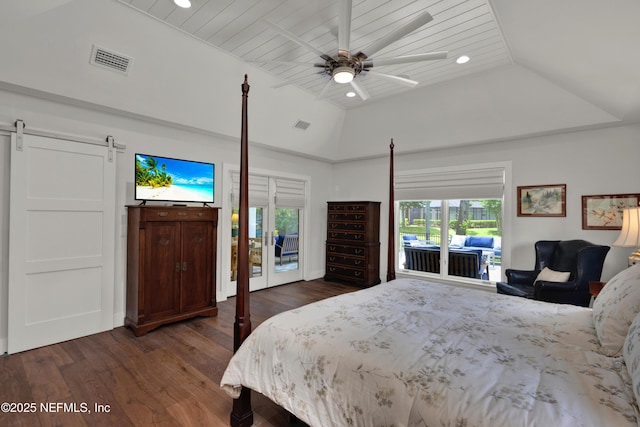 bedroom featuring a barn door, dark wood-style floors, access to exterior, recessed lighting, and lofted ceiling