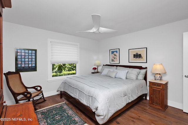 bedroom featuring baseboards, dark wood-type flooring, and a ceiling fan