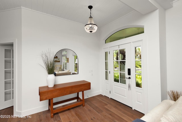 entryway with baseboards, wood finished floors, and wooden ceiling