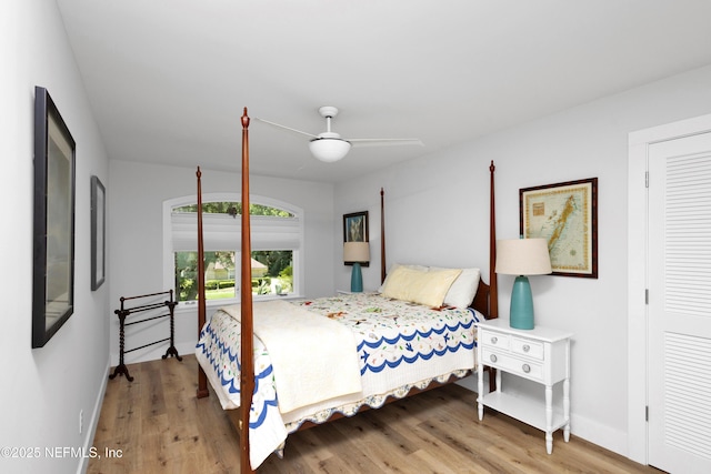 bedroom with wood finished floors, baseboards, and a ceiling fan