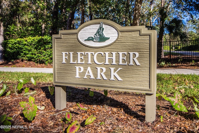 community / neighborhood sign with fence