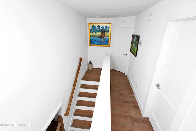 staircase with wood finished floors and baseboards