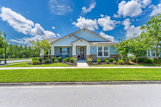 929 Keystone Corners Blvd, Saint Johns, FL 32259 - craftsman house featuring a front lawn, covered porch, and stone siding