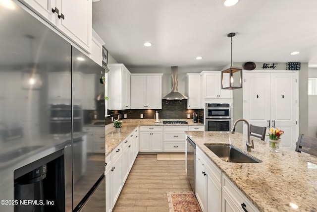 929 Keystone Corners Blvd, Saint Johns, FL 32259 - kitchen featuring appliances with stainless steel finishes, wall chimney range hood, a sink, white cabinets, and recessed lighting