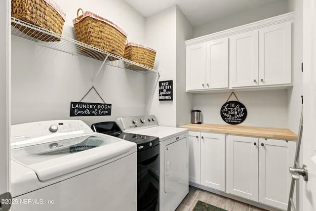 929 Keystone Corners Blvd, Saint Johns, FL 32259 - laundry room featuring washing machine and dryer, cabinet space, and light wood-type flooring
