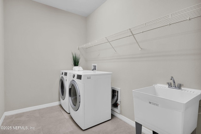 221 Broomsedge Cir, Saint Augustine, FL 32095 - laundry room with washer and clothes dryer, baseboards, and light tile patterned floors