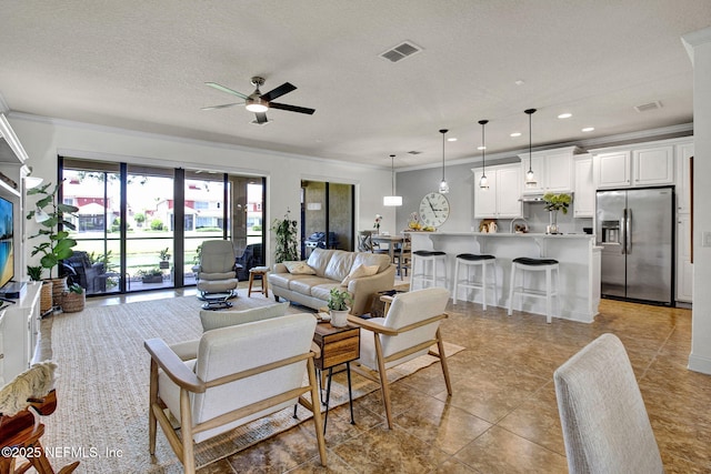 13527 Isla Vista Dr, Jacksonville, FL 32224 - living area featuring crown molding, a ceiling fan, recessed lighting, and a textured ceiling