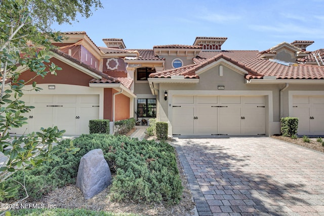 13527 Isla Vista Dr, Jacksonville, FL 32224 - mediterranean / spanish home featuring decorative driveway, stucco siding, a tiled roof, a chimney, and an attached garage