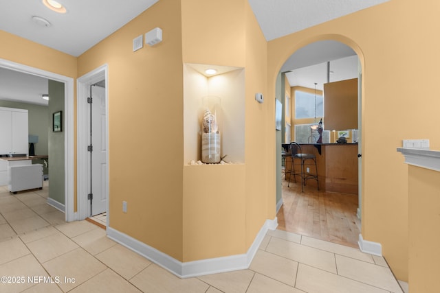 224 Bowles St, Neptune Beach, FL 32266 - corridor featuring arched walkways, baseboards, and tile patterned floors