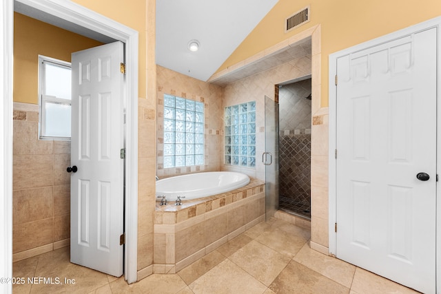 224 Bowles St, Neptune Beach, FL 32266 - full bath featuring vaulted ceiling, tile walls, a garden tub, a stall shower, and tile patterned floors