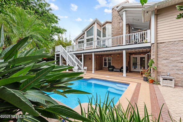 224 Bowles St, Neptune Beach, FL 32266 - swimming pool with french doors, stairway, a patio, and a wooden deck